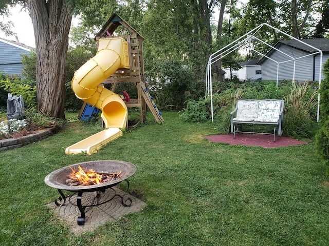 view of yard featuring a fire pit and a playground