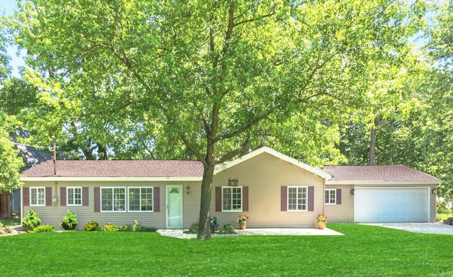 single story home with a garage and a front lawn