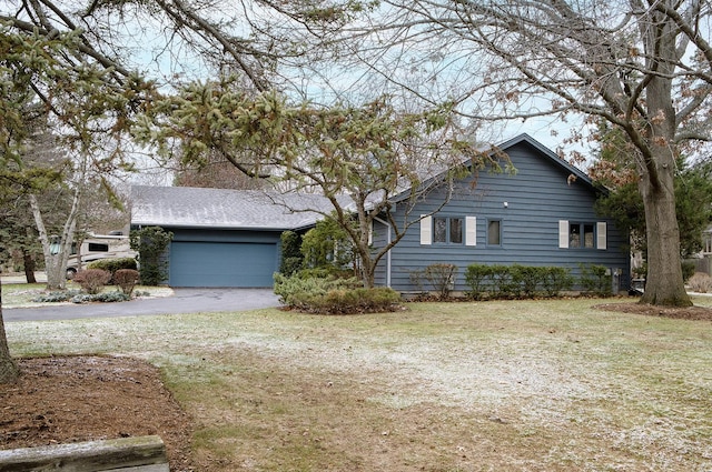 view of front of home with a garage and a front yard