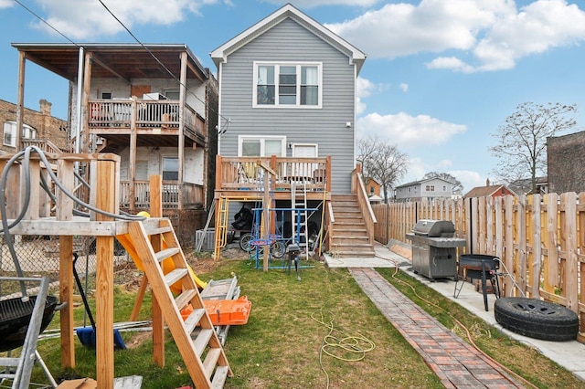 rear view of house with a playground and a yard