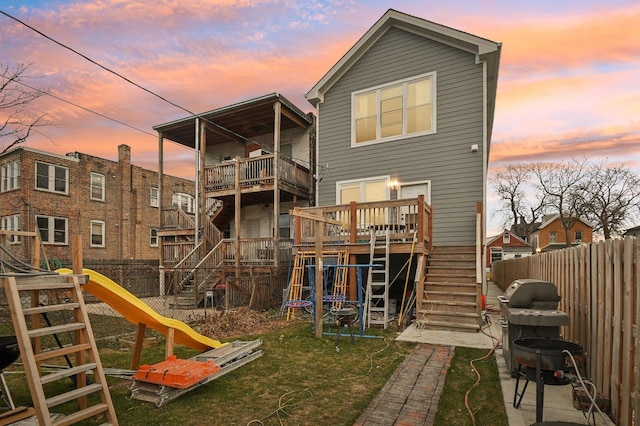 back house at dusk with a playground