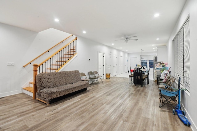 living room with light hardwood / wood-style floors and ceiling fan