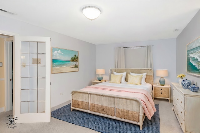 bedroom featuring light carpet