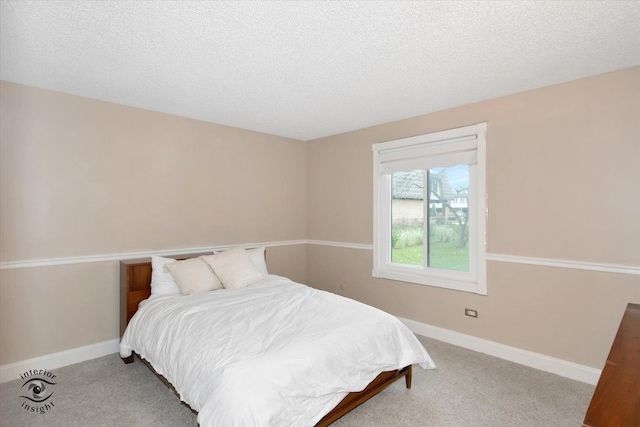 bedroom featuring carpet floors and a textured ceiling