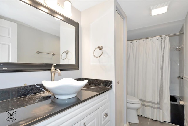 bathroom featuring tile patterned flooring, vanity, and toilet