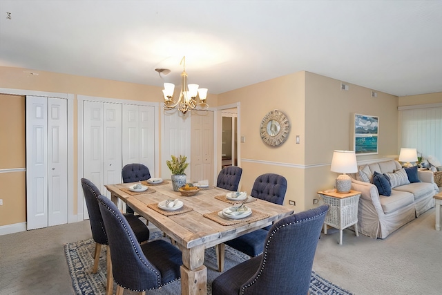 dining area featuring carpet flooring and an inviting chandelier