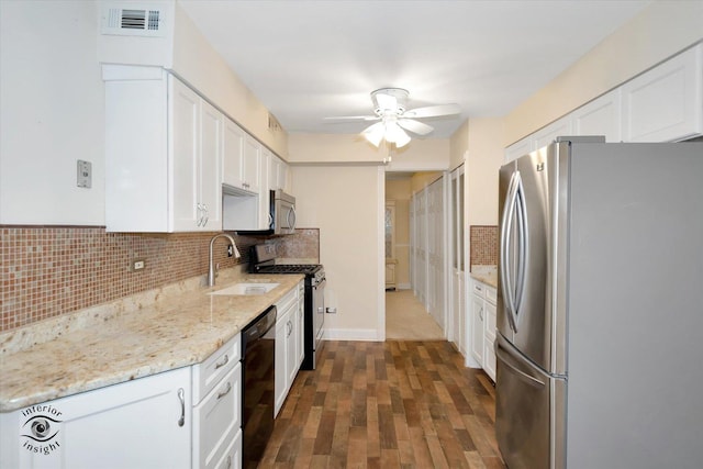 kitchen featuring stainless steel appliances, ceiling fan, sink, white cabinets, and dark hardwood / wood-style floors