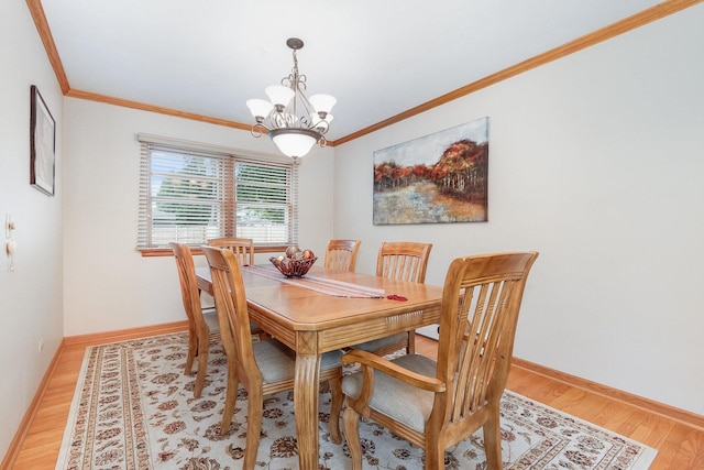 dining room with hardwood / wood-style floors, a chandelier, and ornamental molding