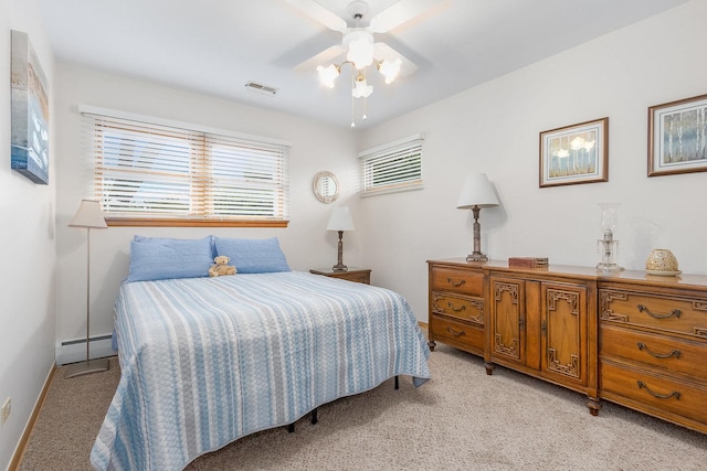 carpeted bedroom featuring ceiling fan and baseboard heating