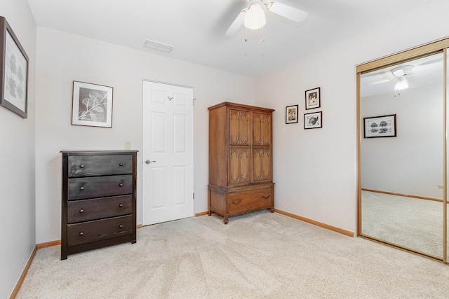 carpeted bedroom featuring a closet and ceiling fan