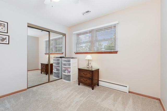 interior space featuring baseboard heating, carpet floors, a closet, and ceiling fan