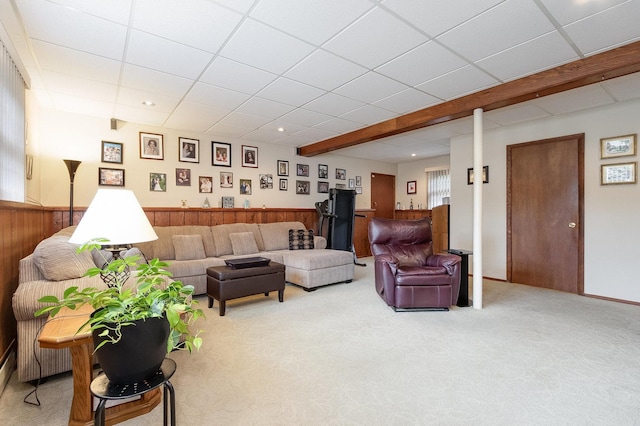 carpeted living room with wooden walls