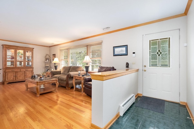 living room featuring hardwood / wood-style flooring, crown molding, and baseboard heating