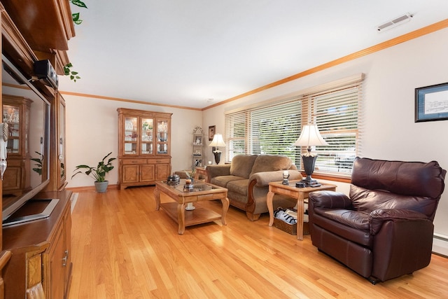 living room with light hardwood / wood-style flooring and crown molding