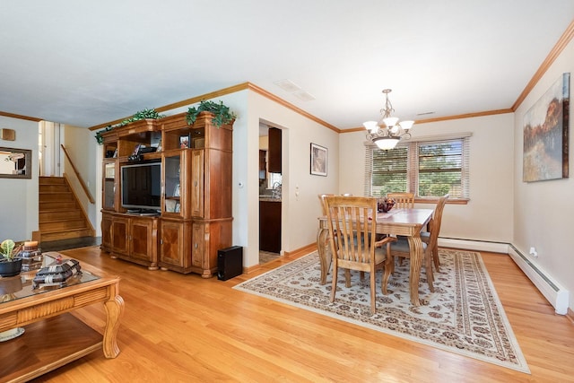 dining room featuring ornamental molding, a notable chandelier, hardwood / wood-style floors, and a baseboard radiator