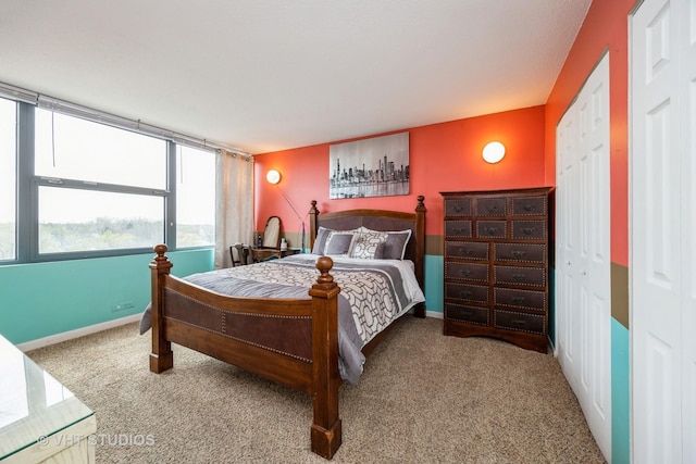 carpeted bedroom featuring baseboards