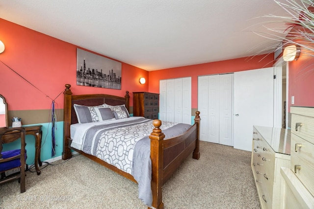 carpeted bedroom featuring two closets