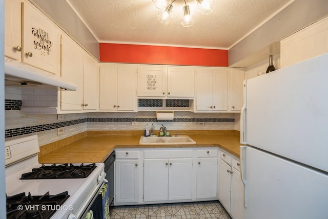 kitchen featuring a sink, white cabinets, a textured ceiling, white appliances, and under cabinet range hood