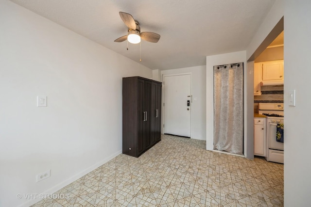 unfurnished room with baseboards and ceiling fan