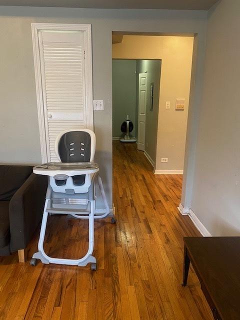 hallway with hardwood / wood-style floors