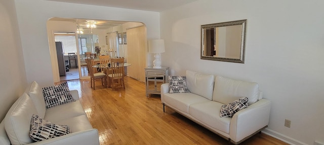 living room with hardwood / wood-style flooring and ceiling fan