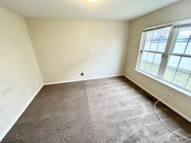 carpeted empty room featuring plenty of natural light