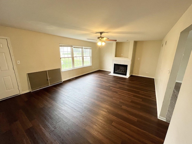 unfurnished living room featuring ceiling fan and dark hardwood / wood-style floors