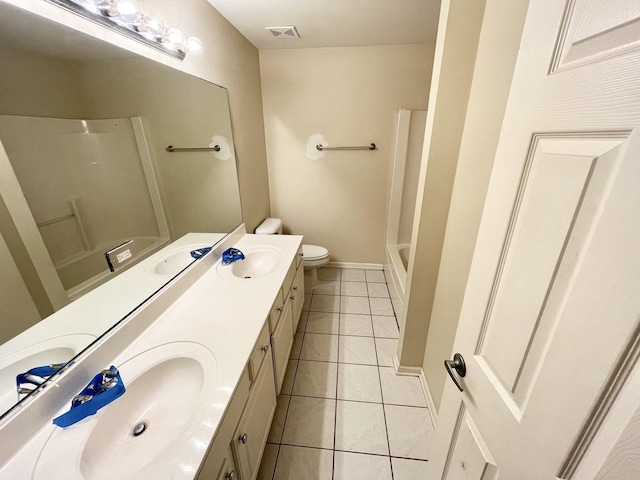 bathroom with tile patterned flooring, vanity, and toilet