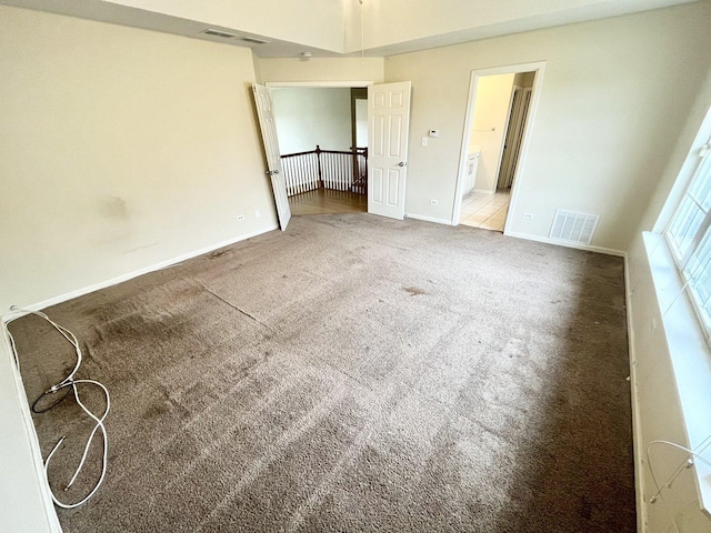 unfurnished bedroom featuring carpet flooring and ensuite bath