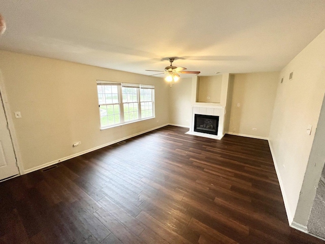 unfurnished living room with ceiling fan and dark hardwood / wood-style flooring