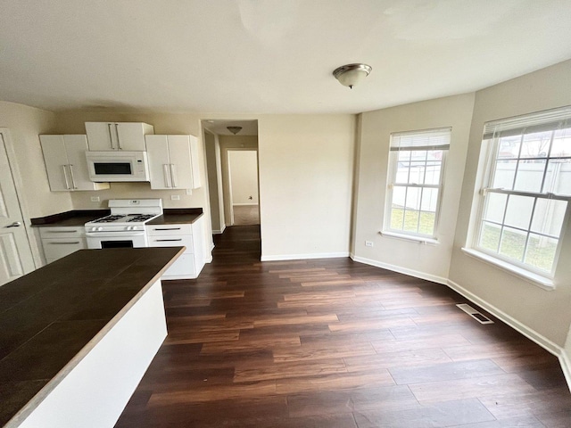 kitchen featuring white cabinets, white appliances, and dark wood-type flooring