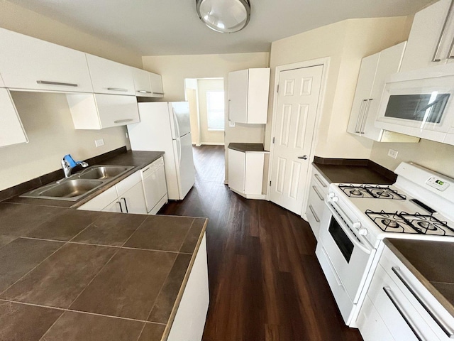 kitchen featuring white cabinetry, sink, dark wood-type flooring, and white appliances