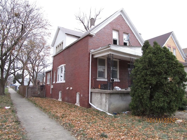 view of side of home with covered porch