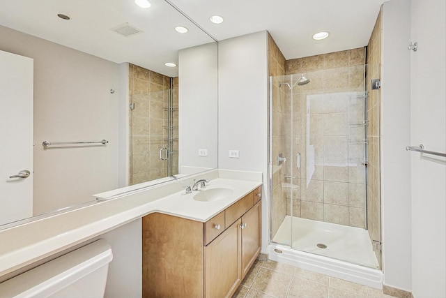 bathroom featuring an enclosed shower, vanity, and tile patterned floors