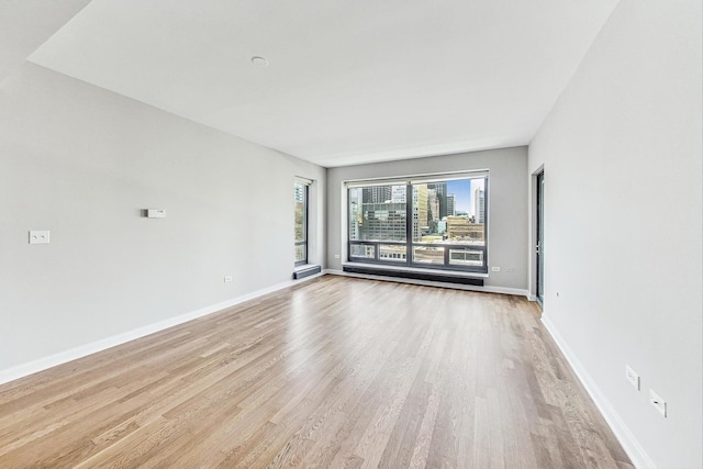 spare room featuring light hardwood / wood-style flooring