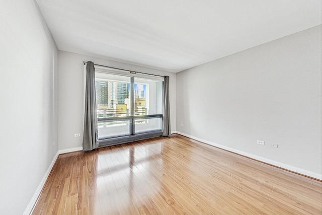 empty room with hardwood / wood-style flooring