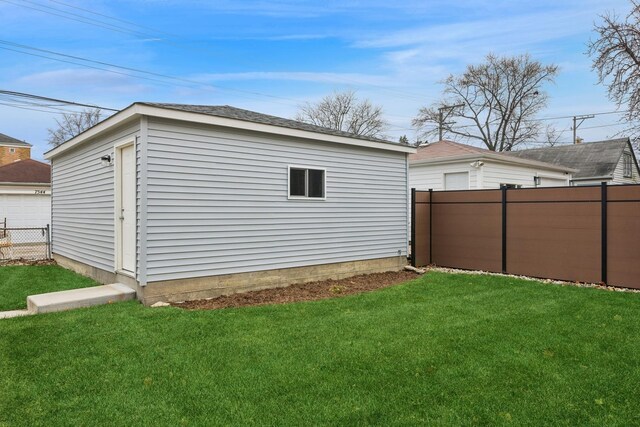 exterior space with a yard, an outdoor structure, and fence