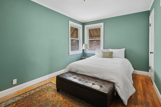 bedroom featuring wood finished floors and baseboards