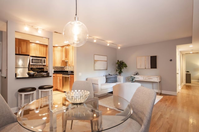 dining area with light hardwood / wood-style flooring