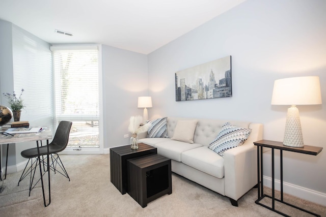 living room featuring light carpet and a wealth of natural light