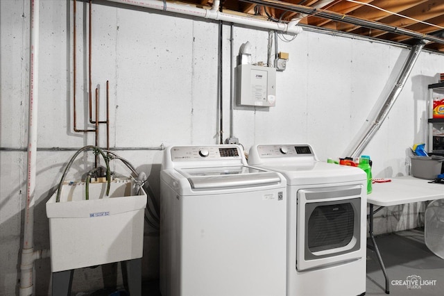 washroom featuring independent washer and dryer and sink