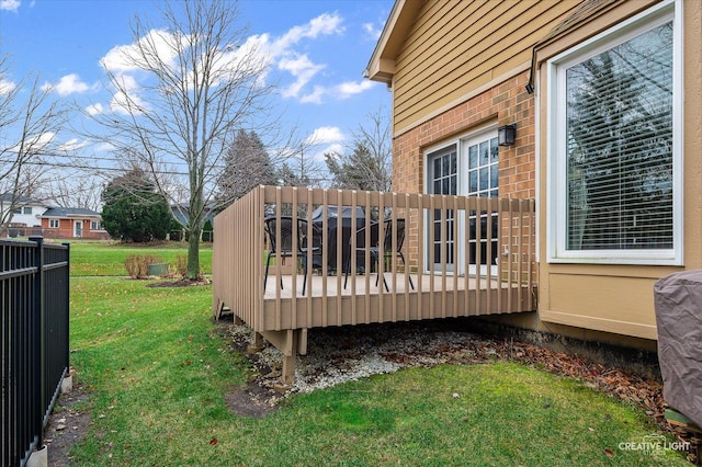 wooden deck featuring a yard