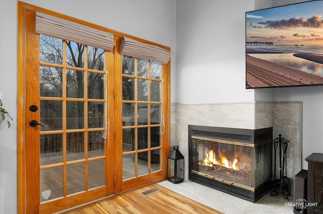 room details featuring a multi sided fireplace and wood-type flooring