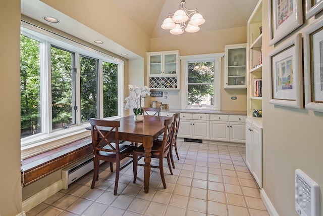 dining area featuring light tile patterned flooring, a notable chandelier, and lofted ceiling