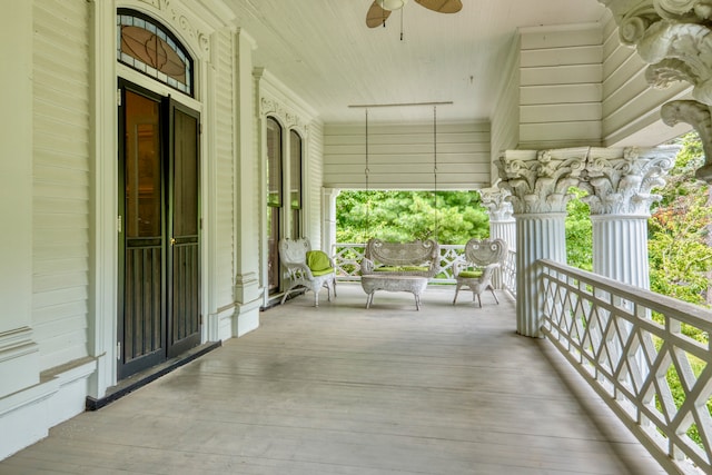 balcony with covered porch and ceiling fan