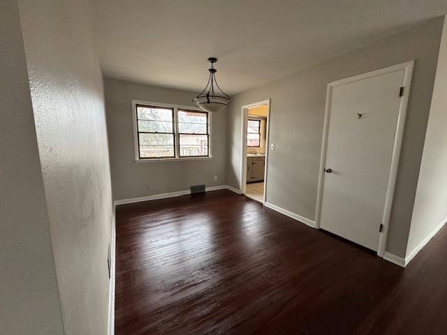 unfurnished room featuring dark hardwood / wood-style flooring