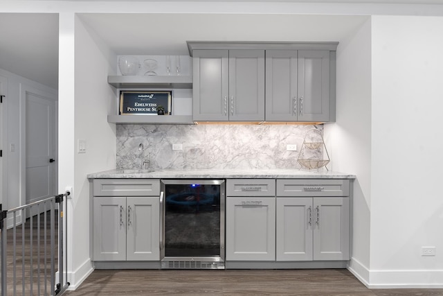 kitchen featuring dark wood-style floors, wine cooler, open shelves, and gray cabinetry