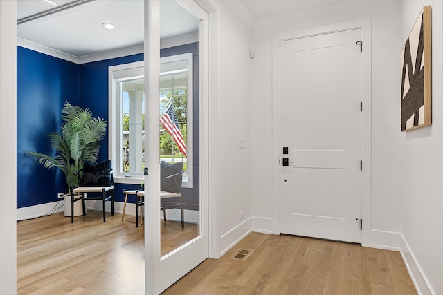 doorway with crown molding, recessed lighting, visible vents, wood finished floors, and baseboards