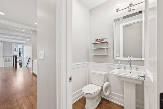 bathroom with hardwood / wood-style floors and toilet