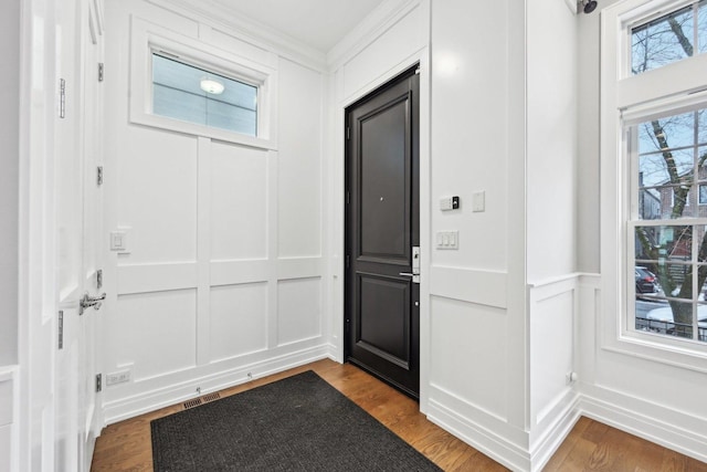 foyer entrance featuring dark hardwood / wood-style flooring and ornamental molding